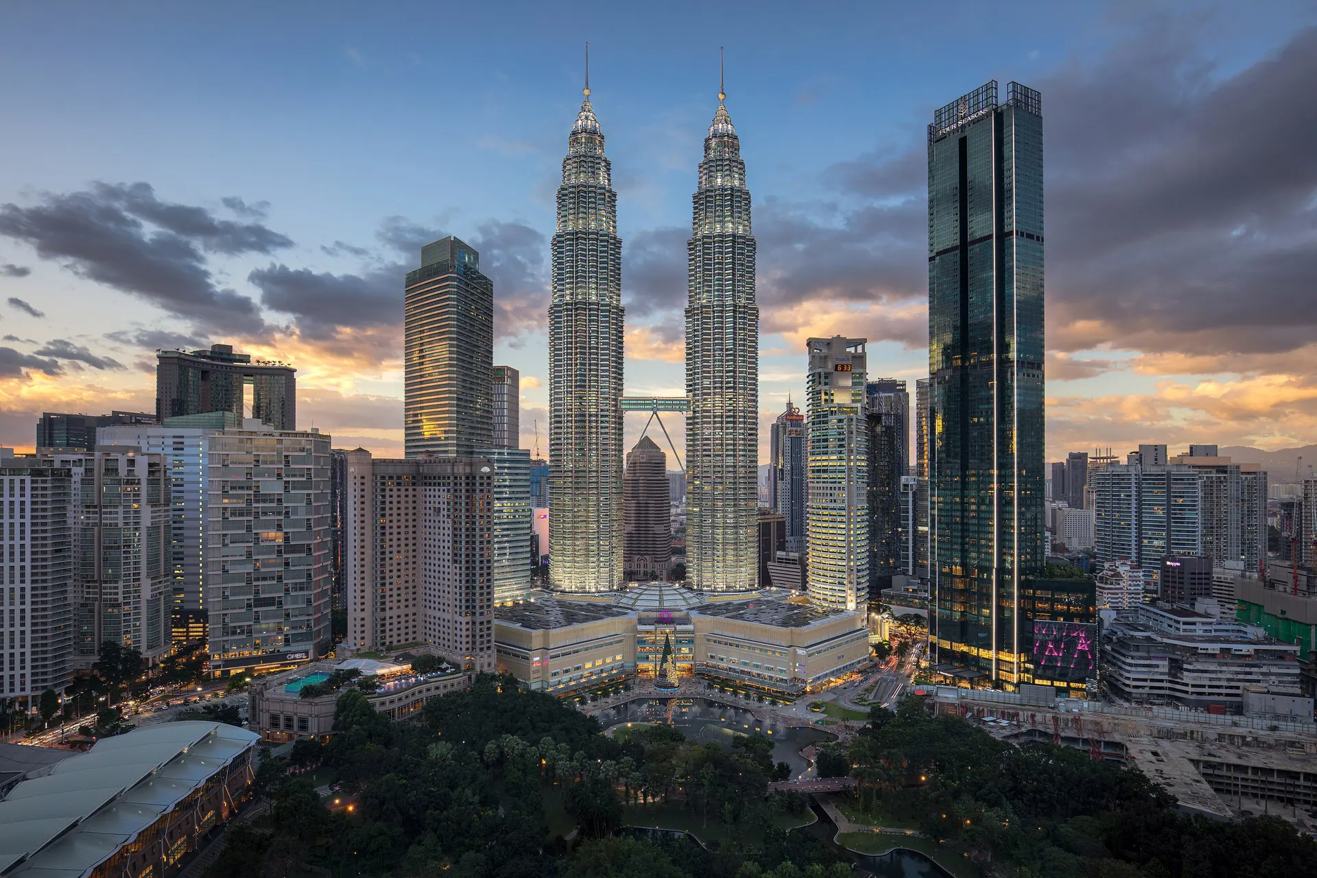 The Petronas Twin Towers and the Kuala Lumpur skyline lit up at dusk